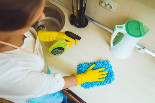 Local specialist cleaning a hard floor in a London home