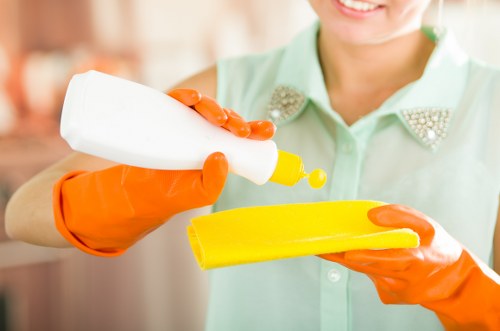 Professional cleaner working in a London home kitchen